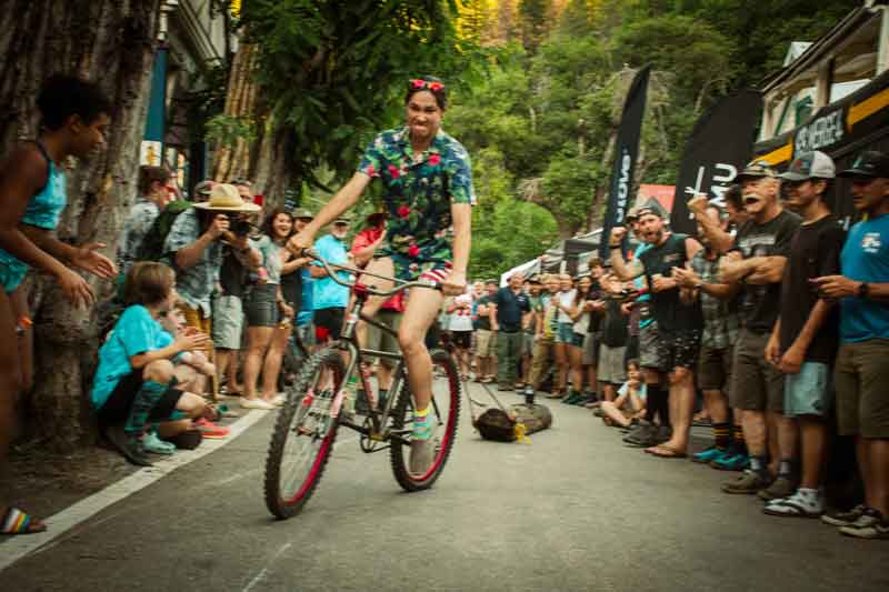 Log Pull competitor pulling long on bike