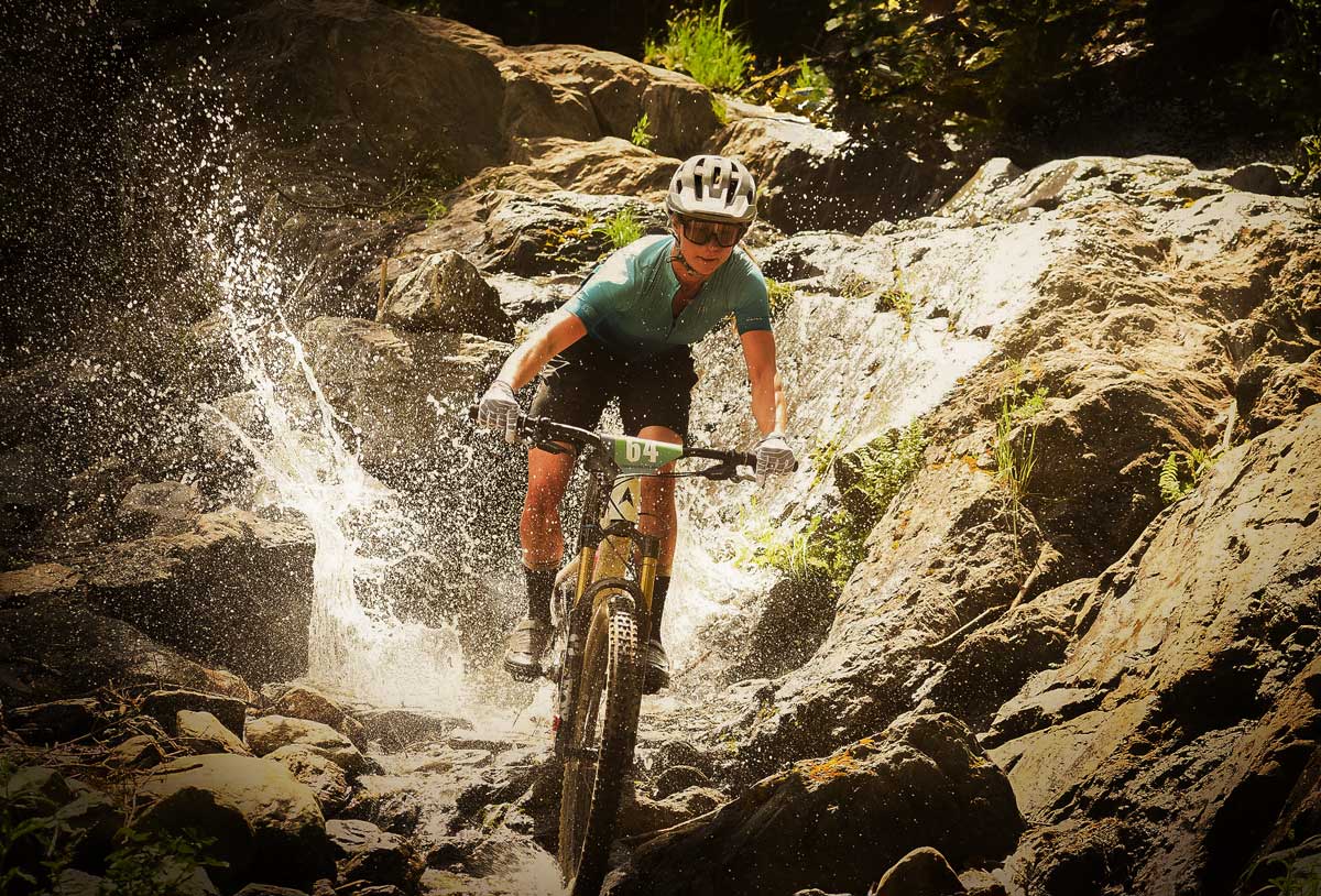 mountain bike racer in the waterfall