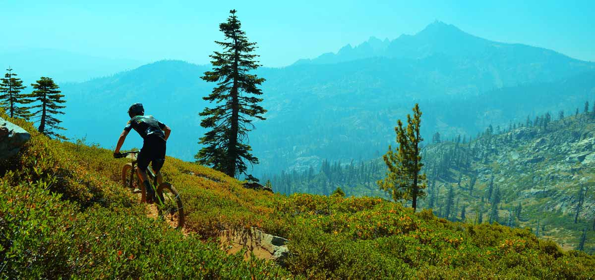 racer on with Sierra Buttes mountains in the background